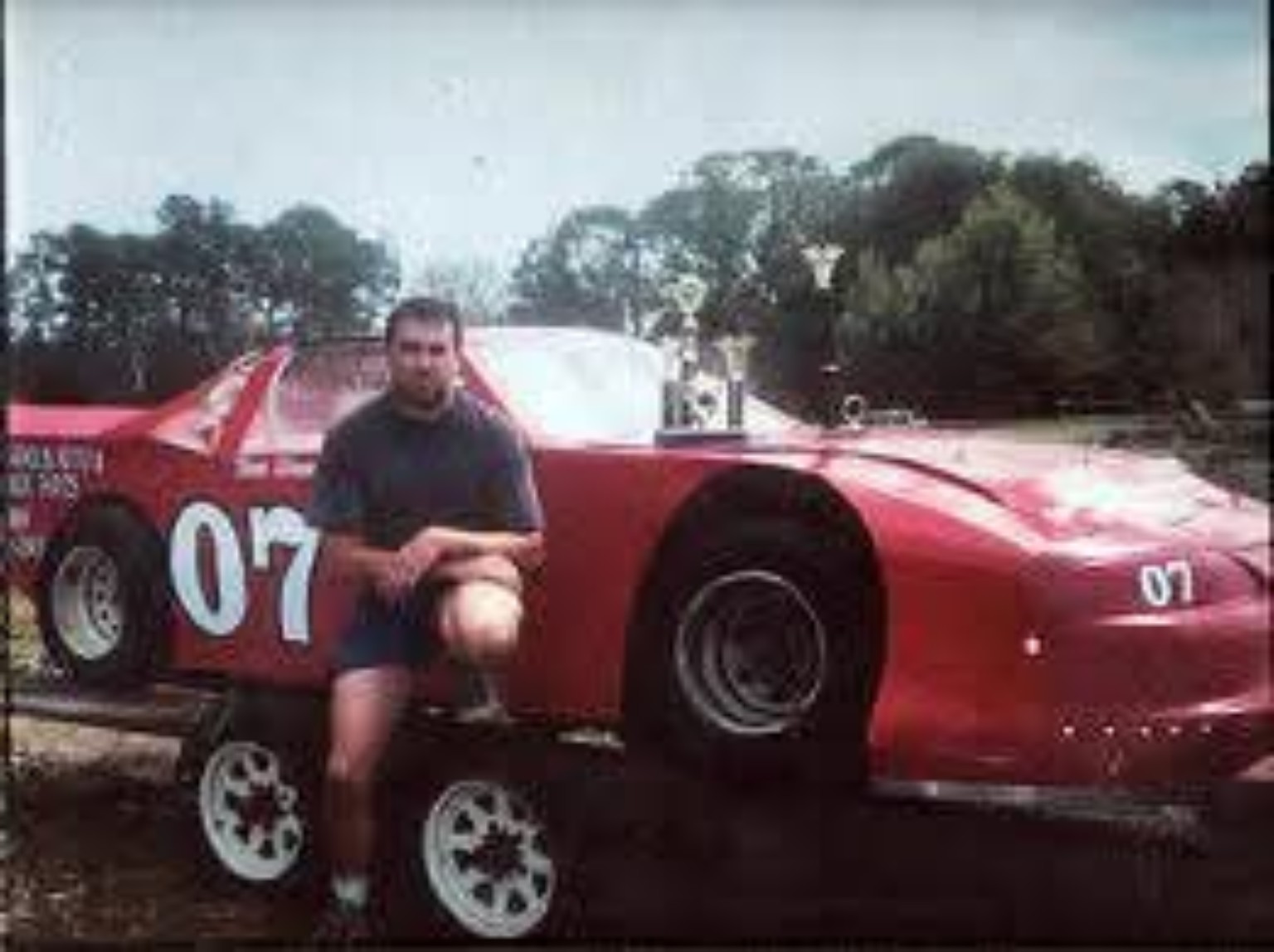 Red number 07 race car with driver